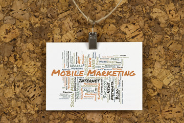 Mobile Marketing word cloud on business card pinned up on cork board