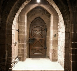 Vintage wooden door, closed, sandstone wall