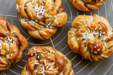 Sweet cinnamon bun rolls on cake rack