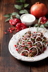 Grilled minced meat skewers kebabs with onions, sumac and pomegranate, selective focus