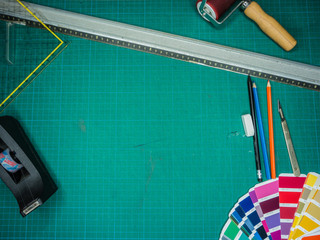Cutting mat with various stationary tools, shot from above