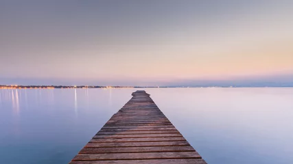 Stof per meter Long Wooden Wharf on Garda lake at sunset © fotografiecor