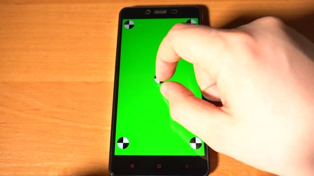 Smartphone with green screen chromakey on the table