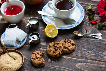 Fruit tea with lemon, milk,honey,orange, pomegranate, on a woode