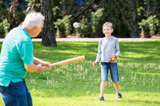 Grandson And Grandfather Playing Baseball