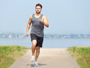 Man jogging on river background