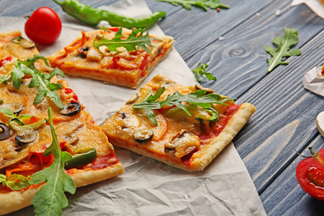 Delicious pizza slices on parchment