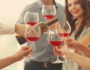 People with glasses of red wine, closeup
