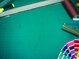 Cutting mat with various stationary tools, shot from above