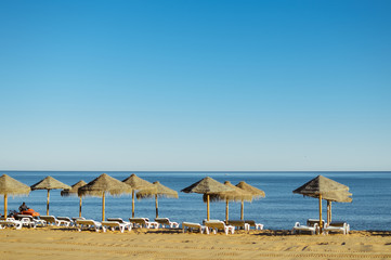 Beach umbrella chairs on the sunny blue sky beach outdoors background