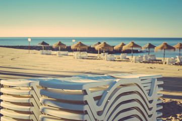 Beach umbrella chairs on the sunny blue sky beach outdoors background