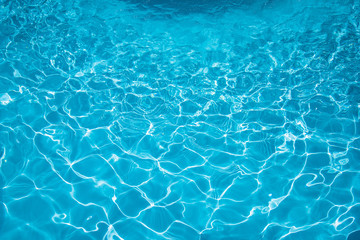 Beautiful ripple water in swimming pool witn sun reflection