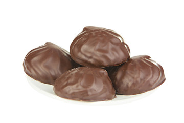 Delicious chocolate marshmallow on plate on white