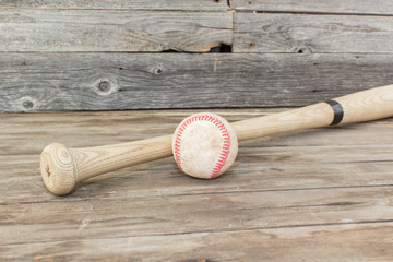 baseball and bat on a rustic wood background