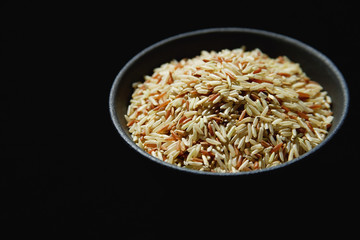Still life of Bowl of rice against black background