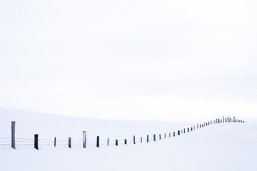 A long fence buried under significant amount of snow on the Camas Prairie near Sun Valley, Idaho.