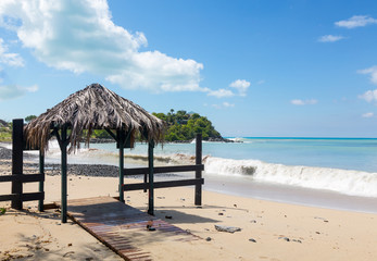 Table and chairs covered by sand on beach