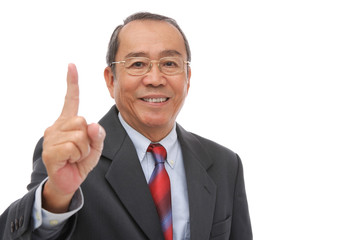 Businessman looking at camera, raising finger