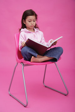 Girl On Chair, Reading A Book, Frowning