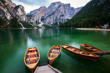 Boats on the Braies Lake ( Pragser Wildsee ) in Dolomites mounta