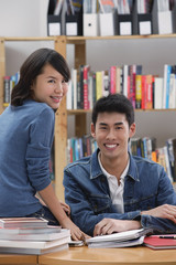 Couple in library, looking at camera