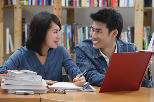 Couple studying together in library