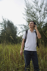 Man talking on mobile phone, hiking, outdoors