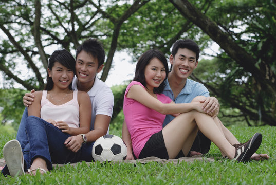 Young adults in park, smiling at camera