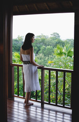 Young woman standing on balcony