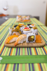Wooden board with assorted sushi pieces