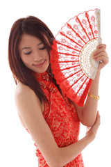 Young woman wearing cheongsam and holding traditional Chinese fan