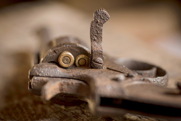Old rusty revolver with handgun's bullets.