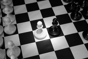 Two chess pawns one opposite to other. Beginning of battle. Concept with chess pieces on a...