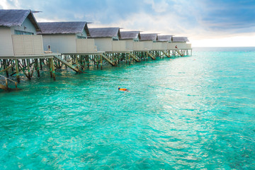 Beautiful tropical Maldives resort hotel with beach and blue wat