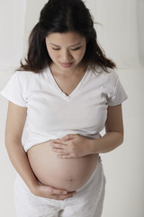 Pregnant woman holding her stomach