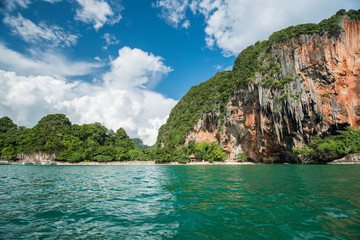 Naklejka na ściany i meble Tropical landscape with rock islands, lonely boat and crystal cl