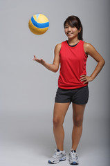 Young woman playing with volleyball