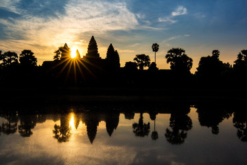 Angkor Wat temple at dramatic sunrise sunburst