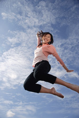 A young woman jumps for joy