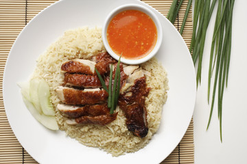 chicken rice with chili sauce on the side on white plate
