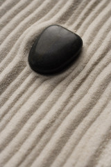 Fototapeta na wymiar closeup of zen garden pebble detail on raked sand