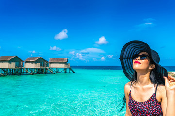 Portrait of happy young woman at beautiful water villa at Maldiv