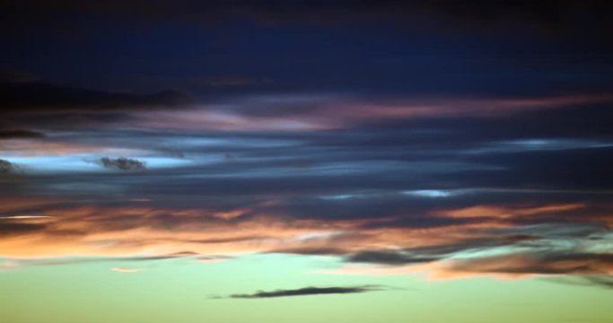 time-lapse of wispy clouds changing color at sunset