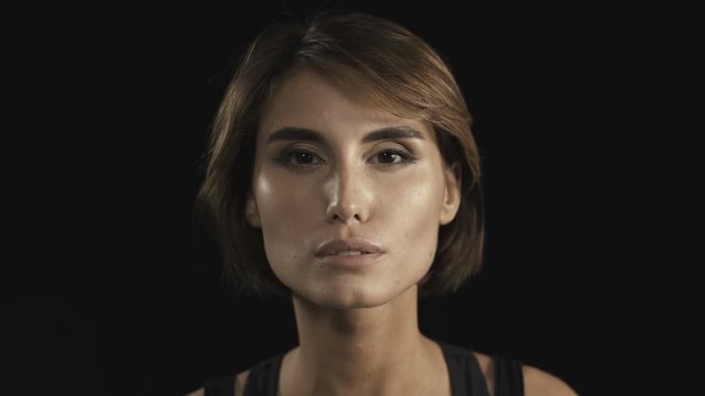 Upset offended young beautiful brunette woman looking at camera