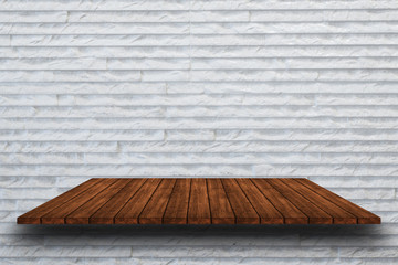 Empty top of wooden shelveson white rough stone wall background,