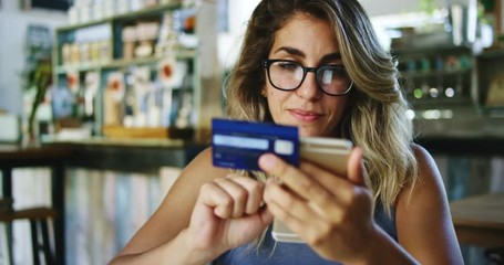 Woman using credit card shopping online with smartphone in cafe - Powered by Adobe
