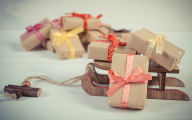 Vintage photo, Wooden sled and wrapped gifts for Christmas or other celebration
