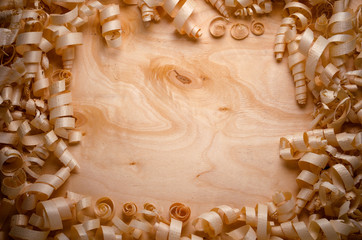 wood shavings on a wooden background with tools