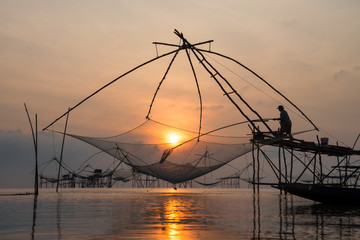 Fototapeta na wymiar Fisherman with giant square dip net at Pakpra canal, Phatthalung, Thailand