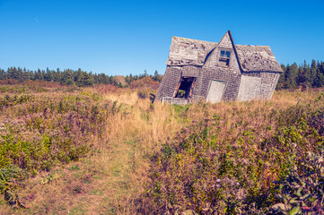 crooked leaning old house with vintage filter